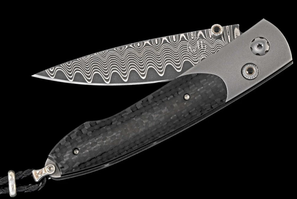 Carbon Titanium pocketknife featuring carbon fiber and 'wave' damascus blade