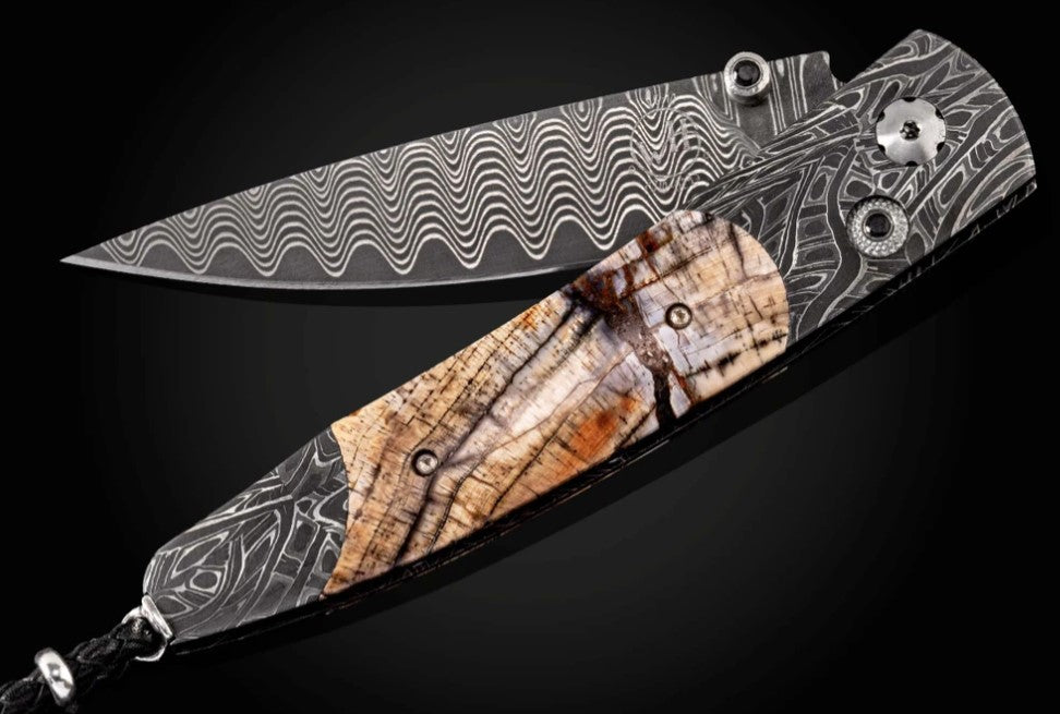 Dark Ring Pocketknife featuring etched damascus, fossil Mammoth tusk, and 'wave' damascus blade