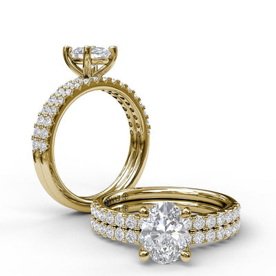 Classic Single Row Engagement ring with an Oval Center Diamond.